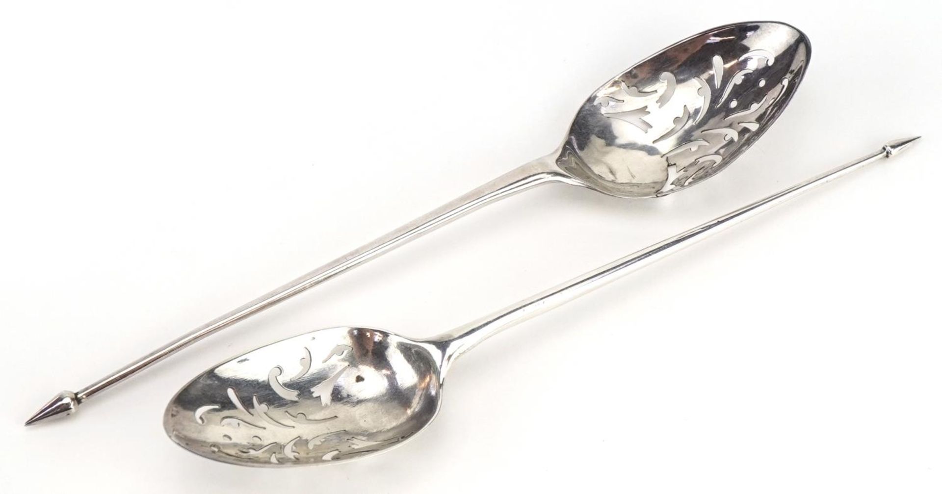 Two 18th century silver mote spoons, each with pierced scroll decoration to the bowls, each