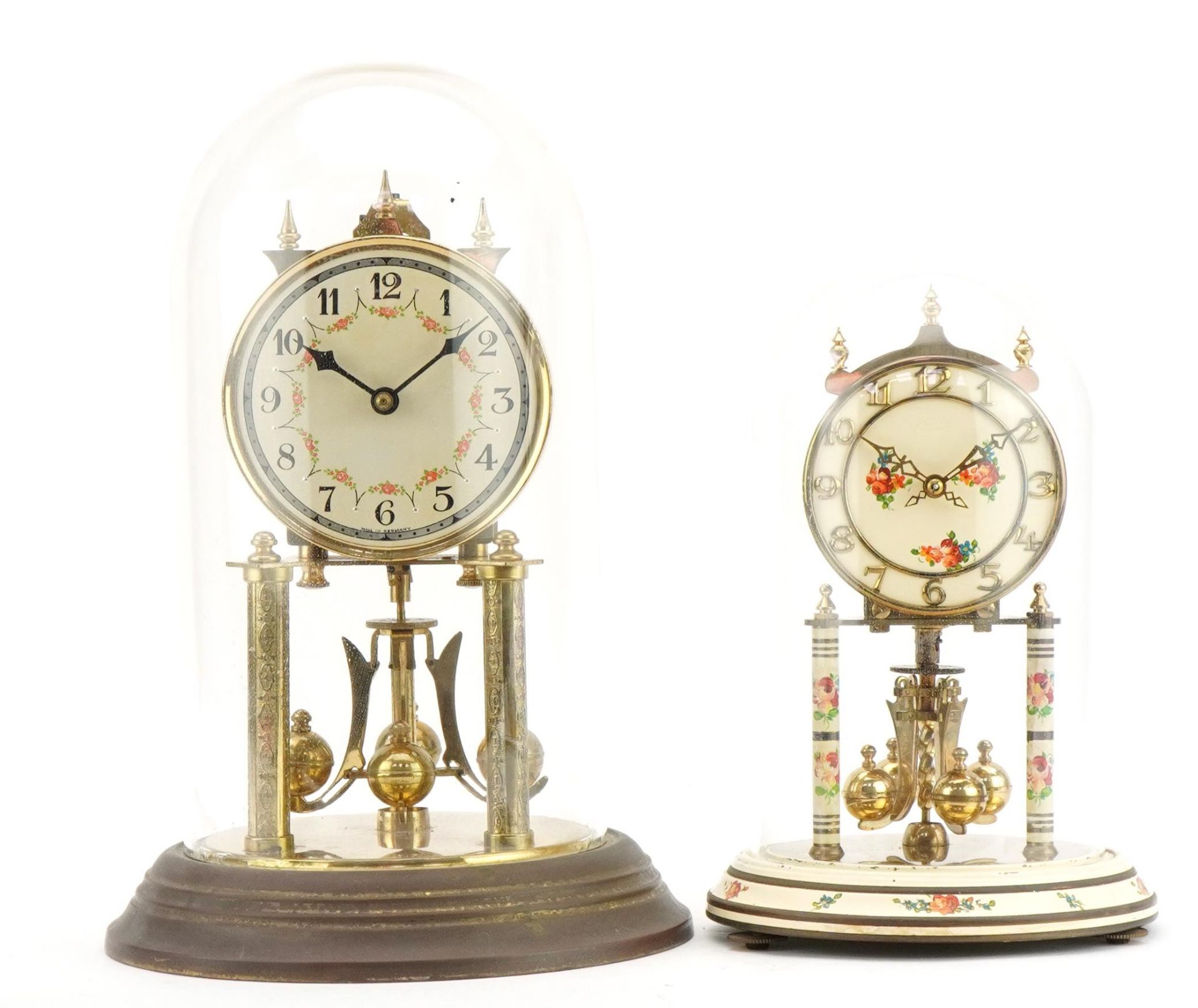 Two brass anniversary clocks housed under glass domes including a Kundo example, the largest 30cm