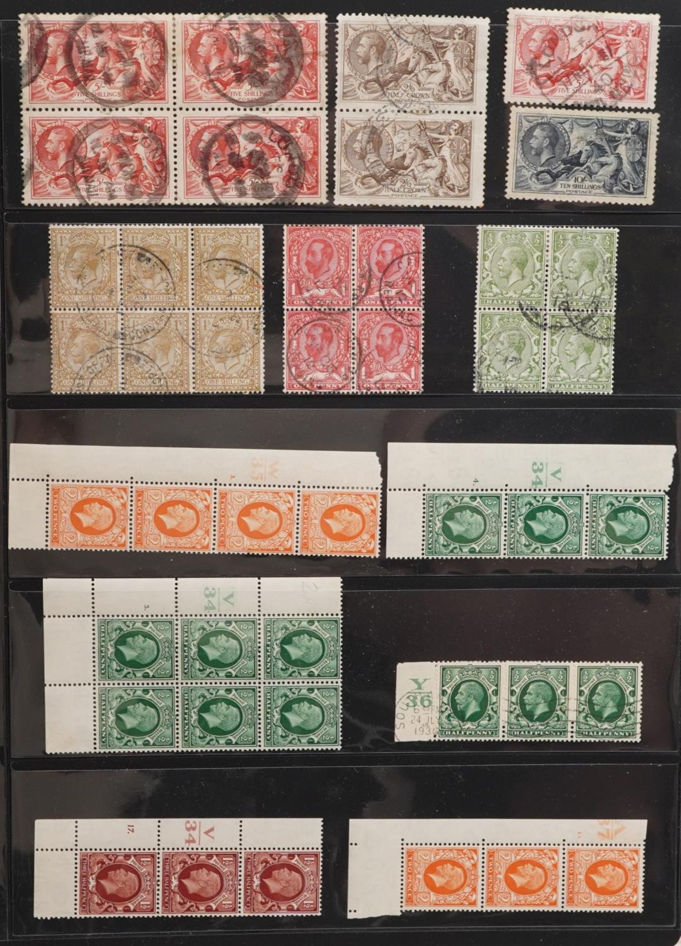 British George V stamps arranged in an album including Seahorses up to ten shillings, blocks and
