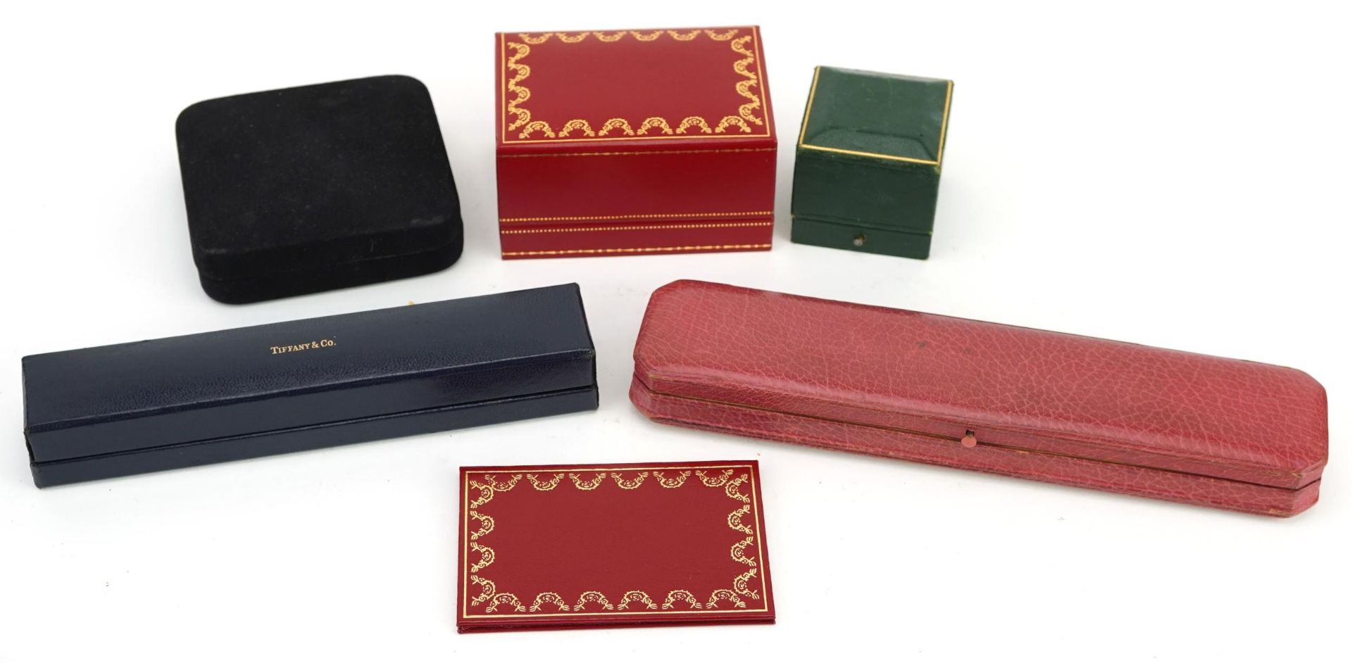 Five antique and later jeweller's boxes comprising Les Must de Cartier wristwatch box,