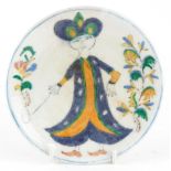 Turkish Ottoman Iznik pottery footed plate hand painted with a figure in traditional dress amongst