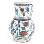 Turkish Ottoman Iznik pottery handled vessel hand painted with stylised flowers, 25cm high : For