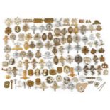 Large collection of British military interest cap badges including 10th Royal Hussars and Royal