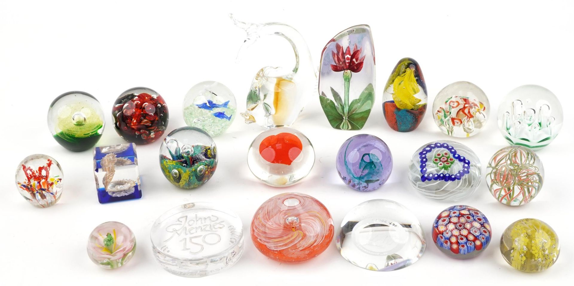 Twenty one colourful glass paperweights including Caithness and a Swedish flower, the largest 19cm