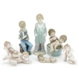 Seven Lladro & Nao porcelain figures including Christmas tree cherubs, the largest 21cm high : For