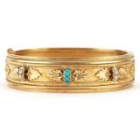 Victorian unmarked gold hinged bangle set with turquoise and seed pearls, decorated in relief with