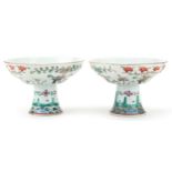 Pair of Chinese porcelain stem bowls hand painted in the famille rose palette with flowers, each