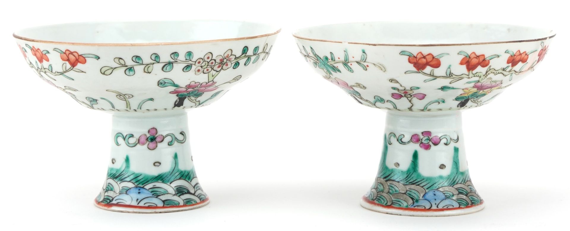 Pair of Chinese porcelain stem bowls hand painted in the famille rose palette with flowers, each
