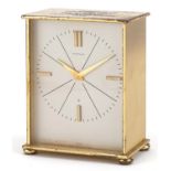 Brass eight day mantle clock retailed by Garrard with silvered dial and presentation inscription,