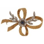 18ct two tone gold diamond and sapphire flower head and bow brooch, 4.5cm wide, 9.8g : For further