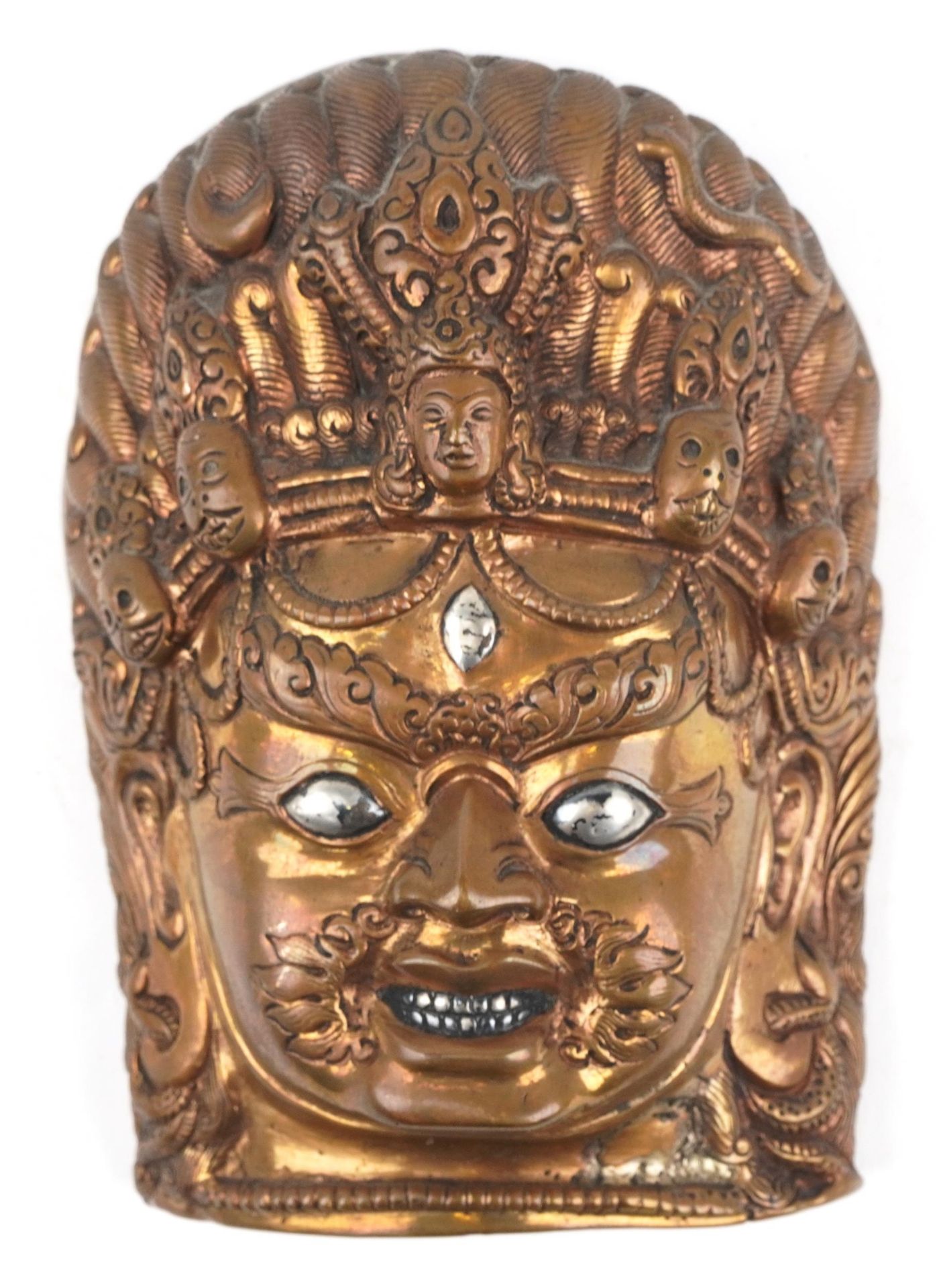 Antique Tibetan or Indian patinated bronze mask of Bhairava with silver eyes and teeth, 13.5cm