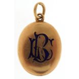 Victorian unmarked gold oval locket with blue enamel monogram, tests as 15ct gold, 3.8cm high, 9.