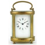 19th century oval brass cased carriage clock with enamelled dial having Roman numerals, 11.5cm