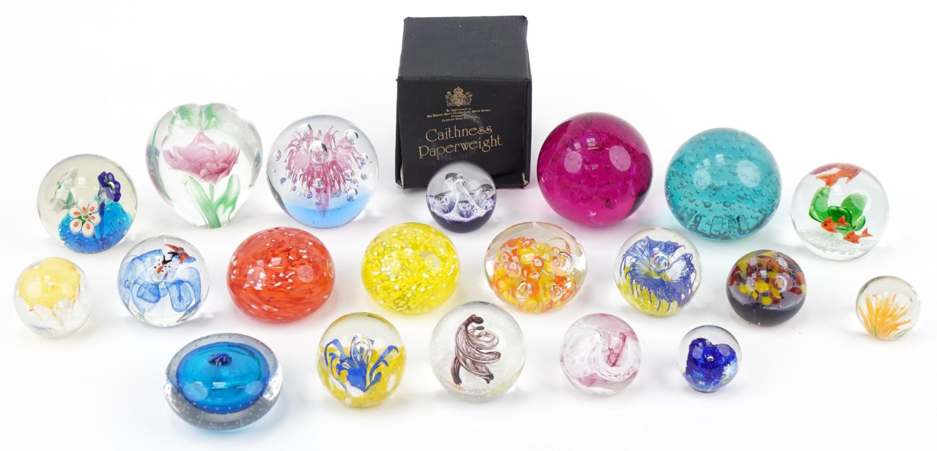 Twenty colourful glass paperweights, one with box, including Caithness Moonflower, Whitefriars and