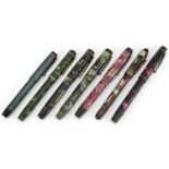 Seven vintage marbleised fountain pens, six with gold nibs, including Conway Stewart 759, Mentone,