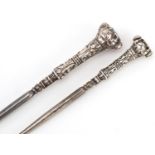 Two Edwardian dog's head silver handled buttonhooks, one with garnet eyes, Birmingham 1906, the