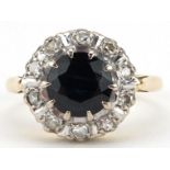 18ct gold sapphire and diamond cluster ring, the sapphire approximately 7.0mm in diameter, size I,