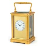 Large French gilt brass carriage clock striking on a gong having circular enamelled dial with