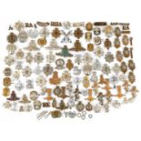 Large collection of British military interest cap badges including Yorkshire Regiment, Army Catering