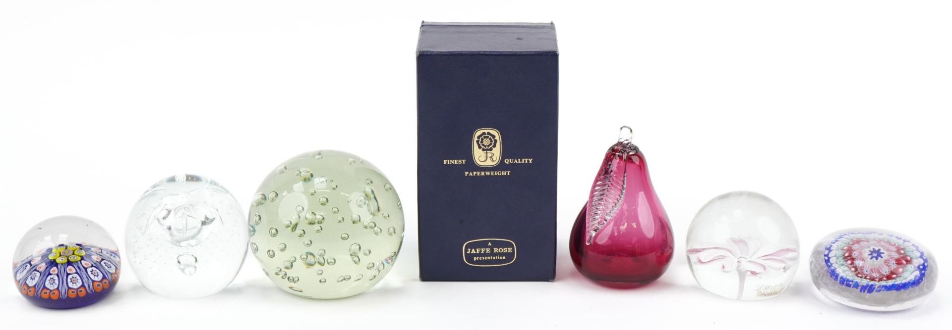 Six colourful glass paperweights including Fratelli Toso Murano flower, Jaffe Rose pear with box,