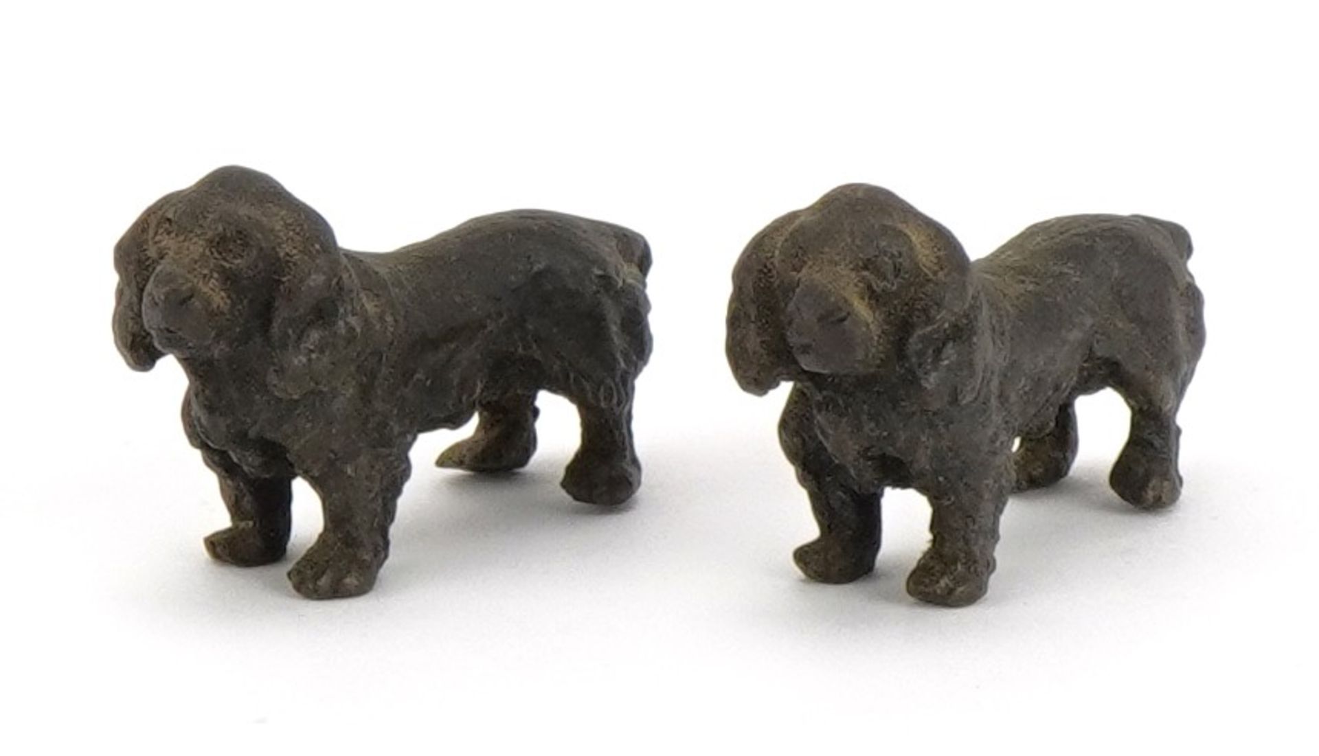Pair of miniature patinated bronze Spaniels, each 3.5cm in length : For further information on