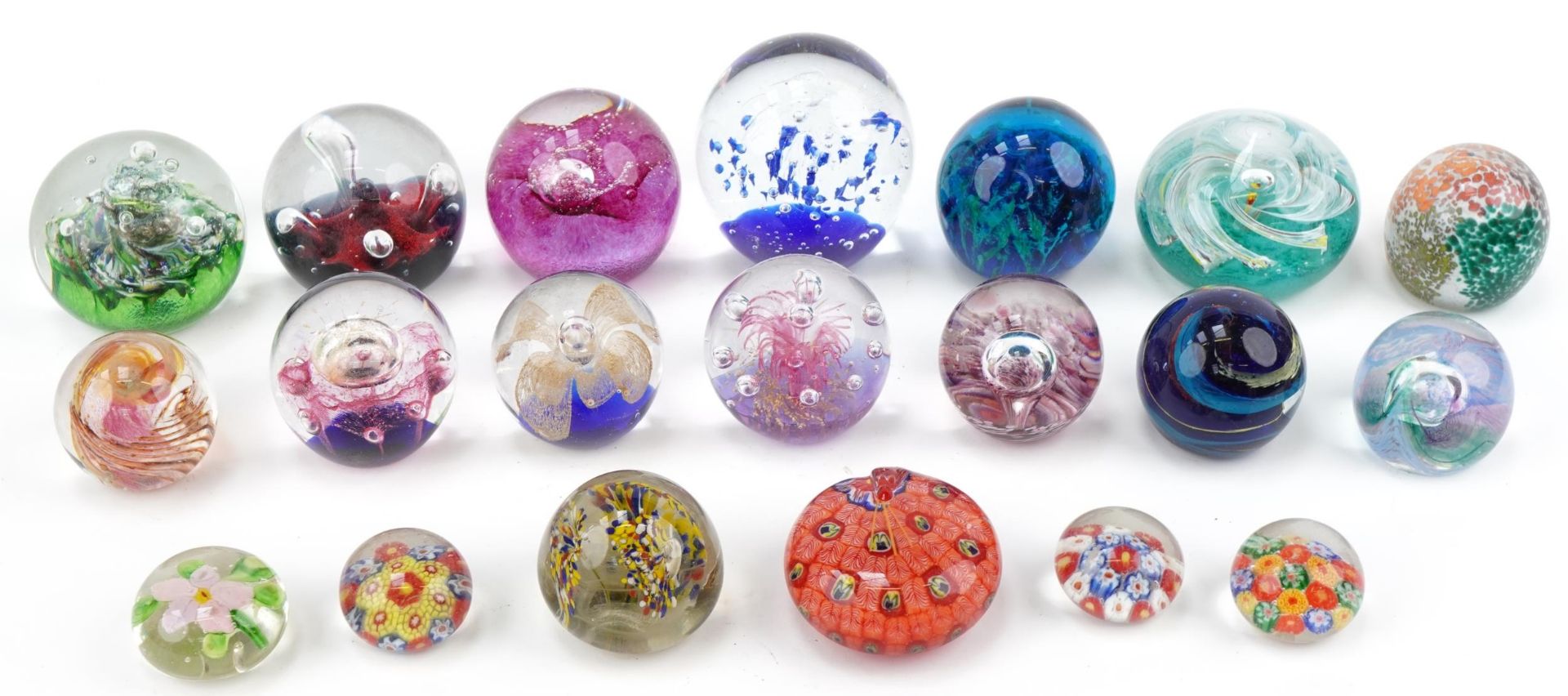 Twenty colourful glass paperweights including Caithness, Mdina and Isle of Wight, the largest 8.