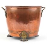 Victorian copper and brass coal bucket with twin handles and three claw feet, 30cm high x 41cm