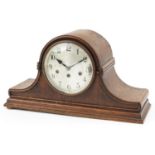Oak cased Napoleon hat shaped mantle clock with Westminster chime, the silvered dial with Arabic