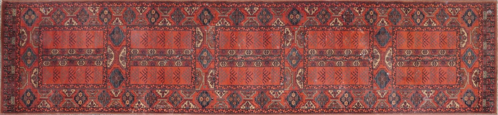 Persian red and blue ground carpet runner having an all over geometric design, 350cm x 90cm : For