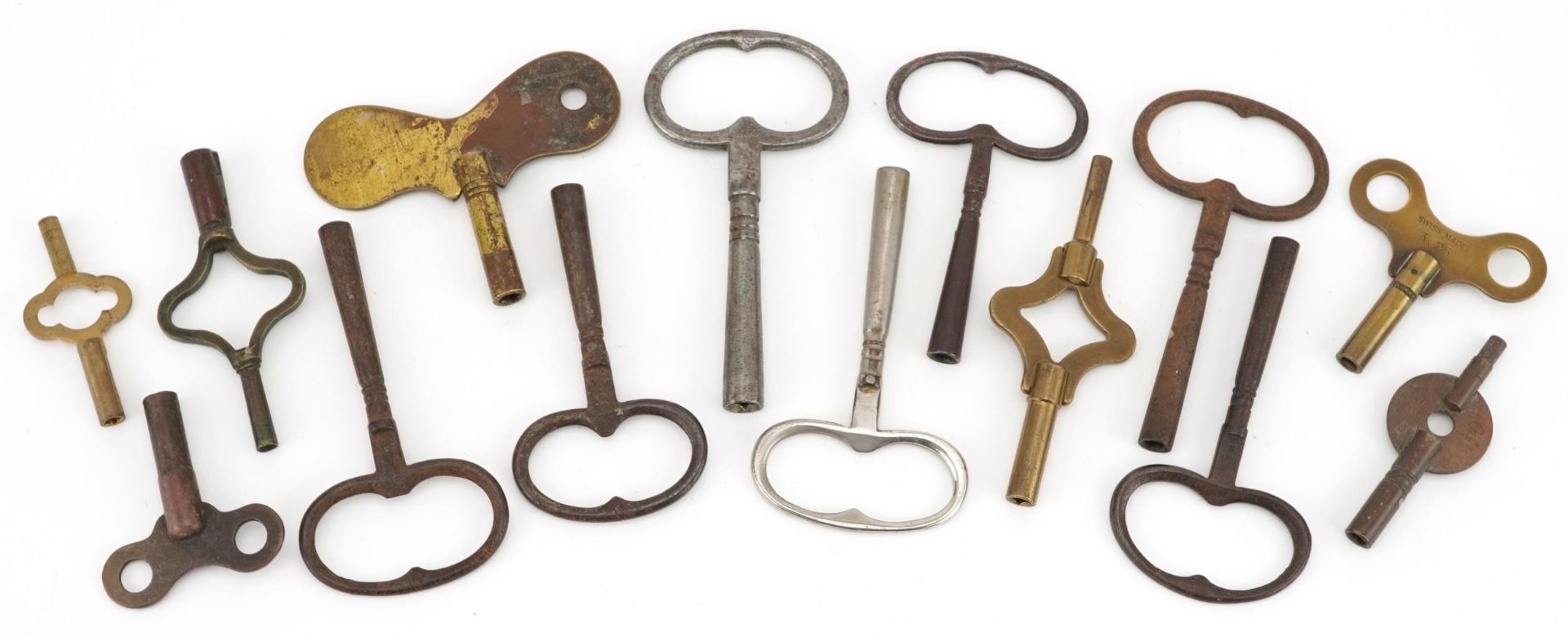 Fourteen assorted antique and vintage clock keys, the largest 8cm in length : For further