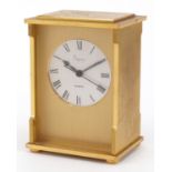 Brass mantle clock retailed by Asprey having circular silvered dial with Roman numerals, 12cm high :