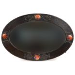 Attributed to Liberty & Co, Arts & Crafts copper wall mirror with bevelled glass having four