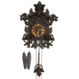 German Black Forest cuckoo clock with weights and pendulum carved with flowers and foliage, the