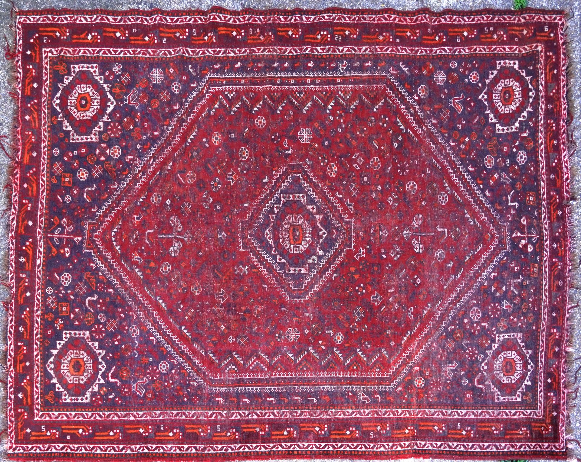 Large Persian red ground rug having an all over geometric design, 270cm x 220cm : For further