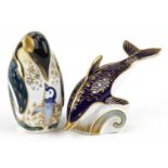 Two Royal Crown Derby animal paperweights with stoppers comprising dolphin and penguin, the