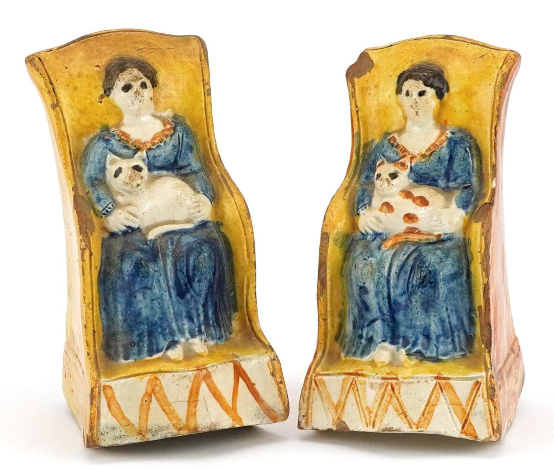 Pair of 19th century Staffordshire pottery rocking figures, each in the form of a female holding a