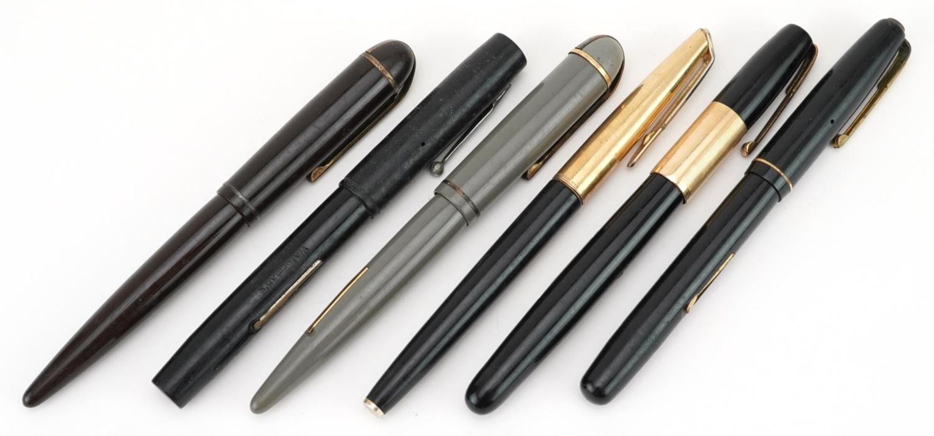 Four vintage Watermans fountain pens and two vintage Eversharp Skyline fountain pens, five with gold