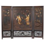 Japanese hardwood and lacquered three fold screen with bone inlay, decorated in relief with two