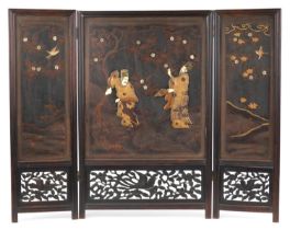 Japanese hardwood and lacquered three fold screen with bone inlay, decorated in relief with two