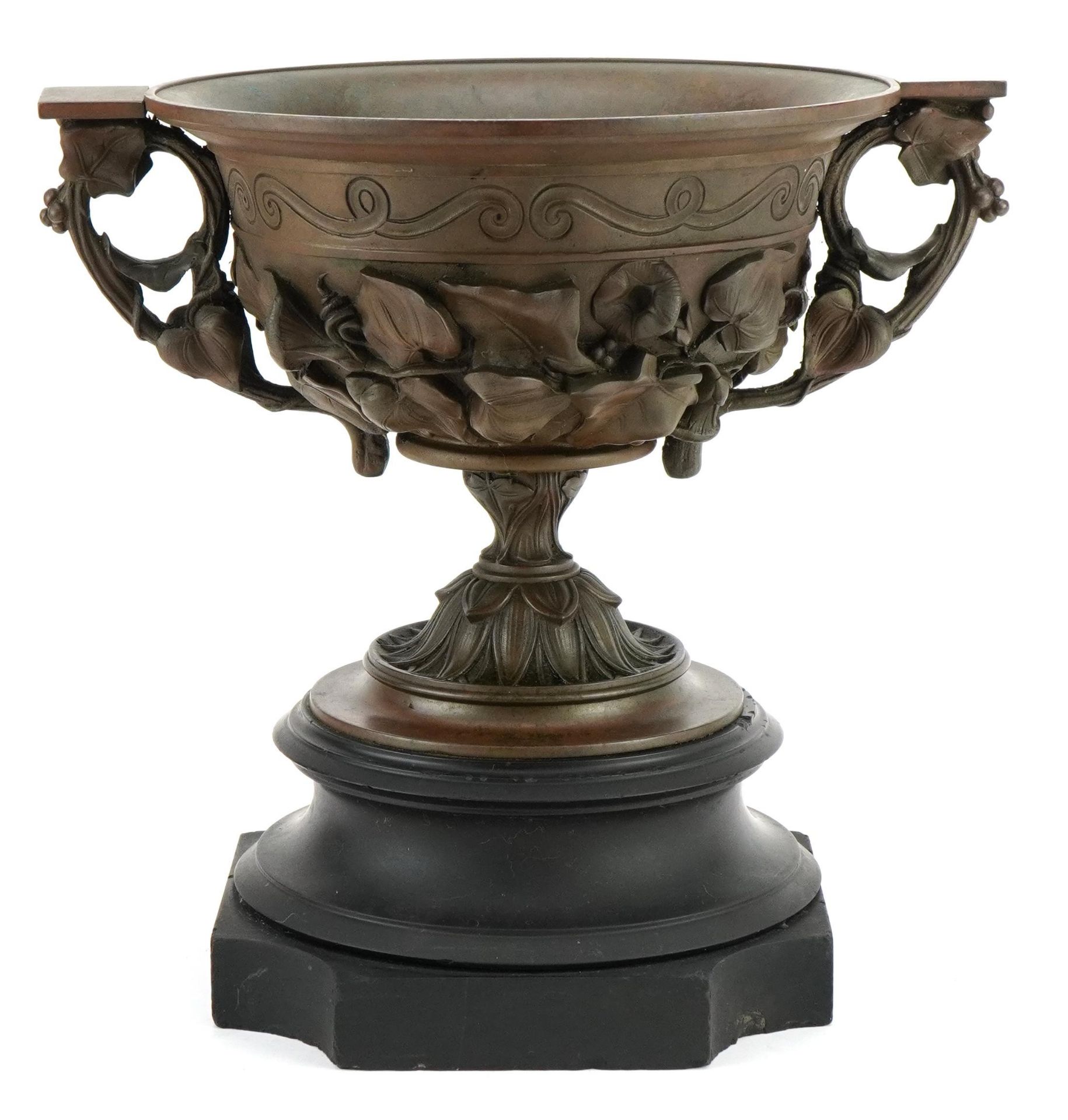Bronzed Campana urn decorated in relief with flowers and twin handles, raised on a black slate - Image 2 of 3