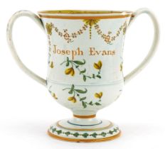 Early 19th century pearlware twin handled loving cup hand painted with flowers, inscribed Joseph