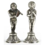 Two continental white metal figures of semi nude male musicians, each 8.5cm high : For further