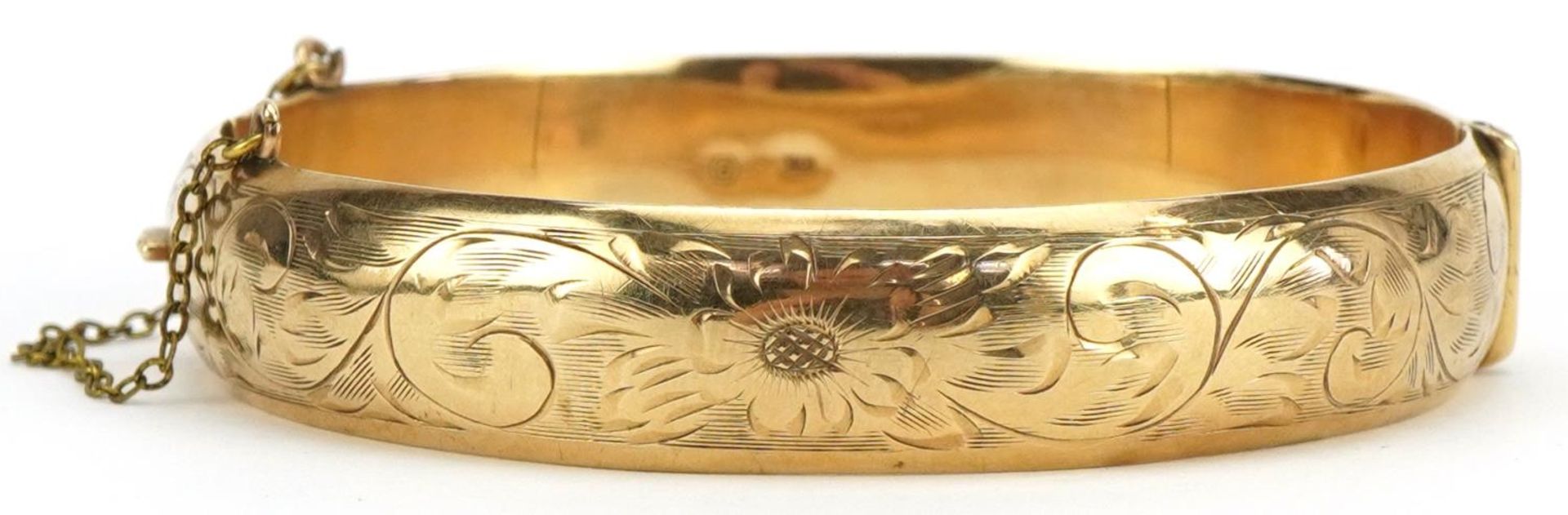 10ct gold hinged bangle engraved with flowers and foliage, 6cm in diameter, 17.7g : For further