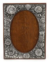 Art Nouveau silver plated copper easel photo frame profusely embossed with flower heads, 28cm x 21cm