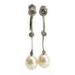 Pair of unmarked white metal diamond and pearl drop earrings with screw backs housed in a fitted