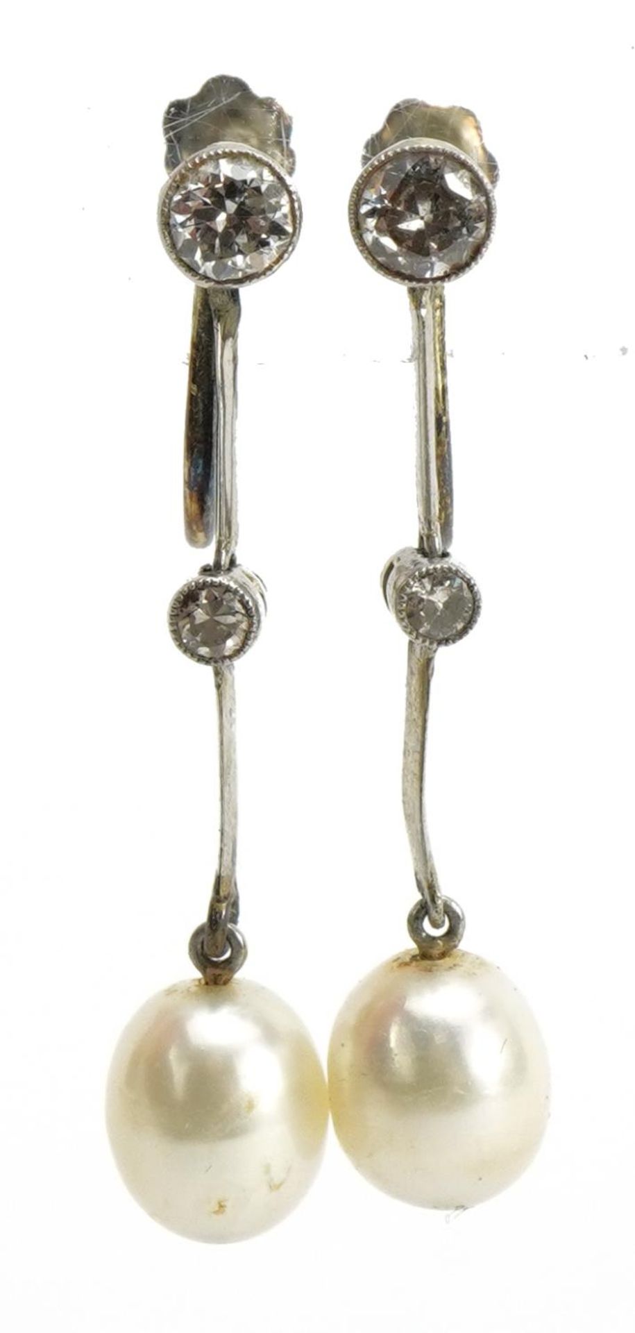 Pair of unmarked white metal diamond and pearl drop earrings with screw backs housed in a fitted
