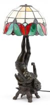 Verdigris bronzed metal figural table lamp with Tiffany design shade in the form of a female, 56cm