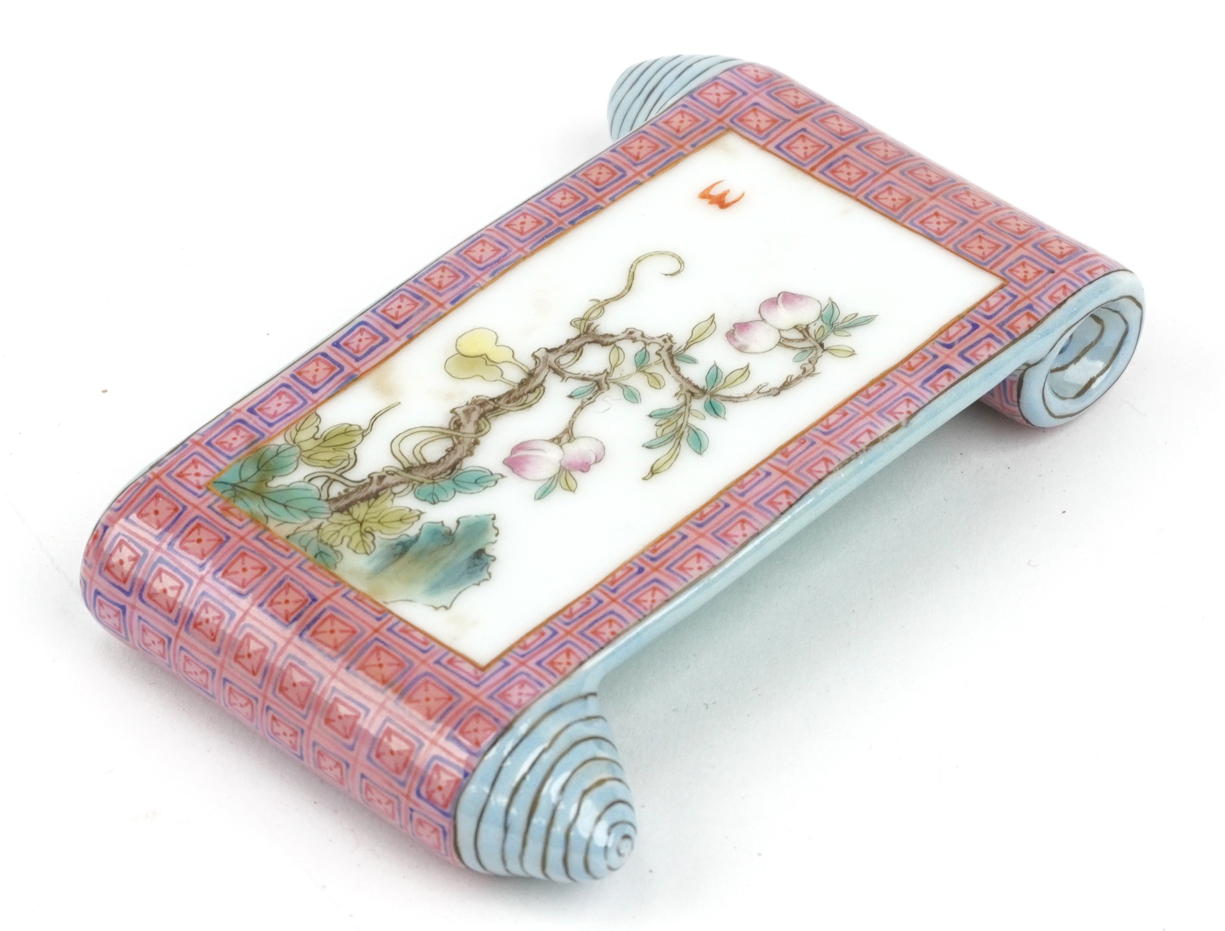 Chinese porcelain scholar's wrist rest in the form of a scroll hand painted in the famille rose