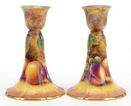 Paul English for Royal Worcester, pair of porcelain candlesticks hand painted with fruit, each