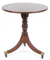 Georgian style mahogany tripod circular occasional table on brass castors, 64cm high x 61cm in